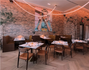 Porta Rossa in all of its elegance. The soft hue of the string lights and the extravagant paintings on the walls elevate the aesthetic of the space. 